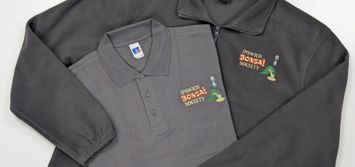Ipswich Bonsai Society branded grey polo shirt and dark grey fleece, customised with their bonsai tree logo.