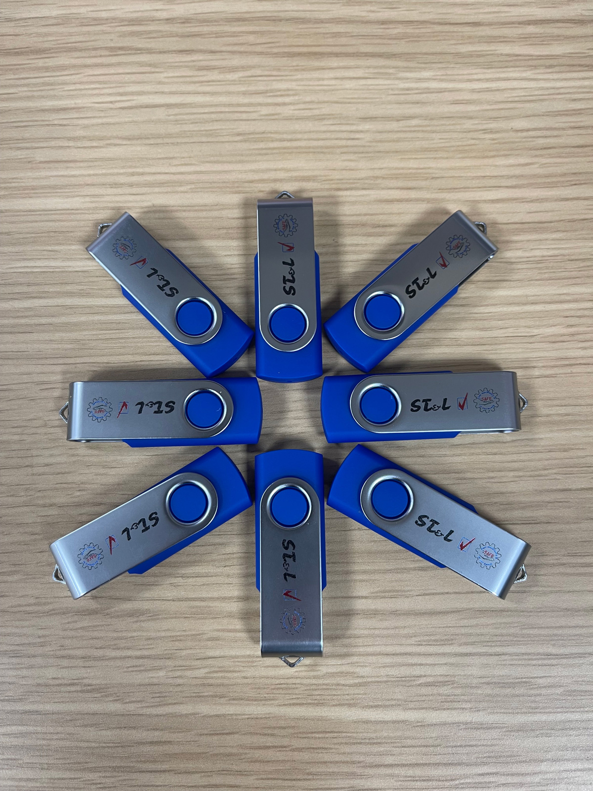 Custom Branded USB Sticks - ST & L ST & L branded blue and silver USB flash drives.