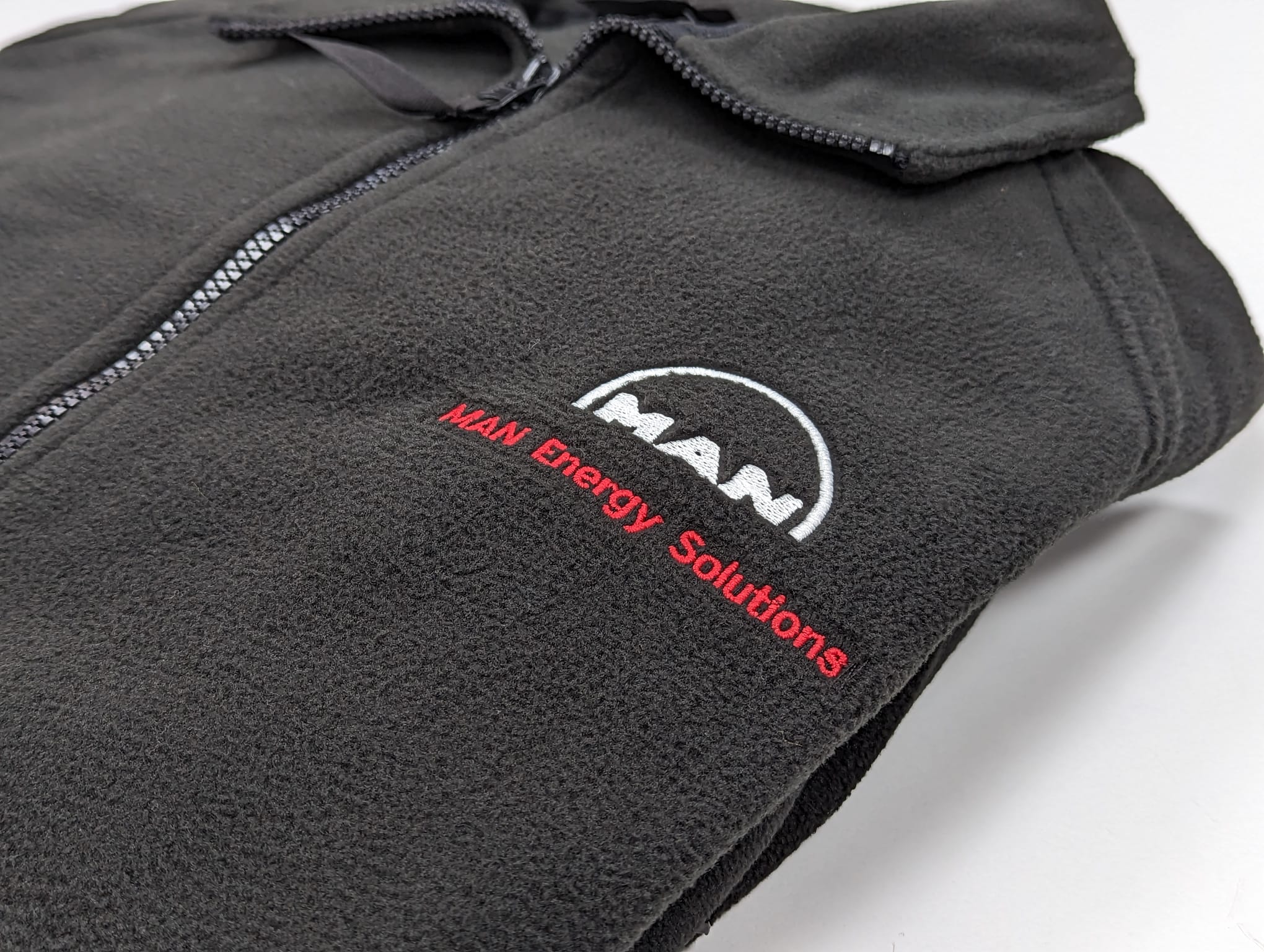Logo Branding on Clothing for MAN Energy Solutions MAN Energy Solutions branded black fleece, customised with their logo.