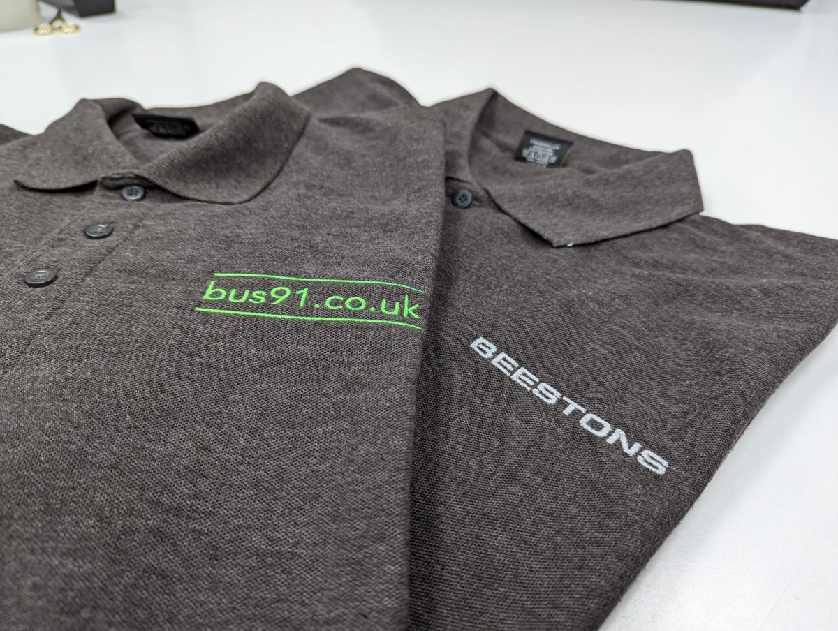 Beestons Custom Polos Beestons branded dark grey polo shirts, customised with their website and company name.