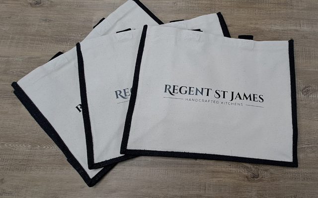 White Westford Mill shopper bags with black trim, custom printed with the Regent St James Handcrafted Kitchens logo.