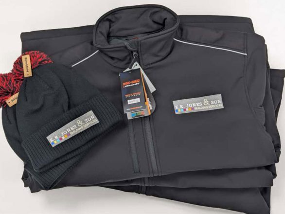 Dark grey Result RS124 waterproof jacket and matching black beanie hat, both embroidered with the K.E. Jones & Son Building Services logo.
